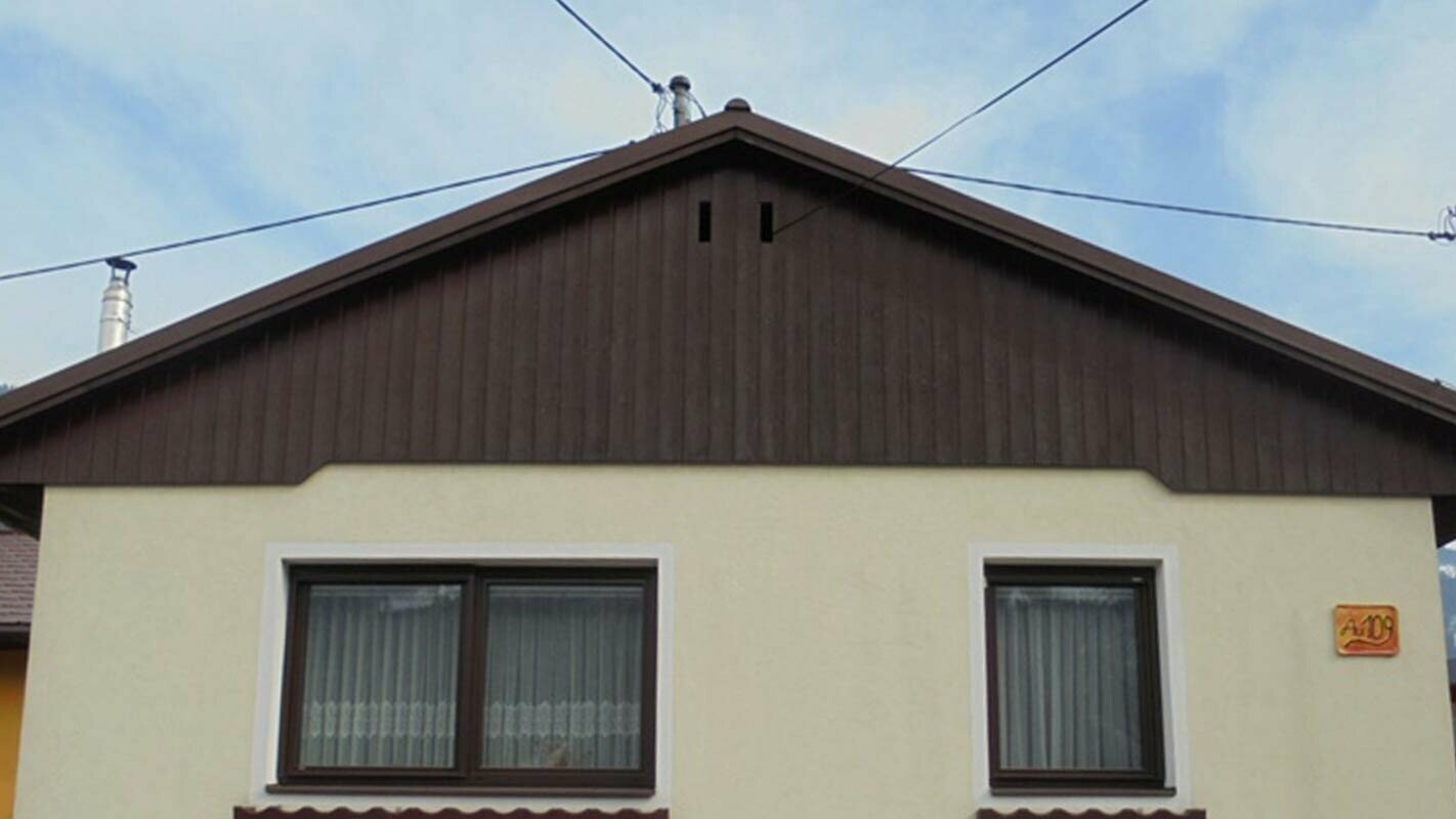 Before renovation of gable façade with PREFA sidings, yellow rendered façade and weathered wood