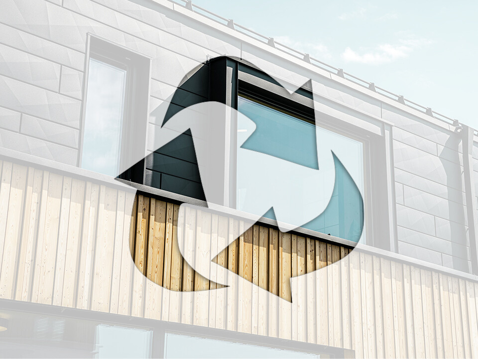 Photo shows the recycling symbol on a house façade with PREFA aluminium elements and wood panels.